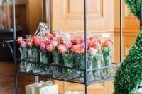 a refined vintage trolley holding party favors and fresh pink blooms is an ideal solution for a Parisian-themed bridal shower