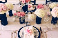 a chic pink, white and black Parisian-themed bridal shower tablescape with neutral and blush blooms, black vases and black chargers is a cool idea