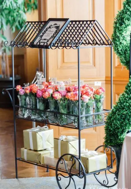 a refined vintage trolley holding party favors and fresh pink blooms is an ideal solution for a Parisian-themed bridal shower