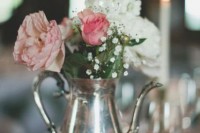 a vintage book with a doily, a silver teapot and white, blush and dusty pink blooms