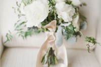 a white peony wedding bouquet with greenery and neutral ribbons is a classic idea of a bouquet