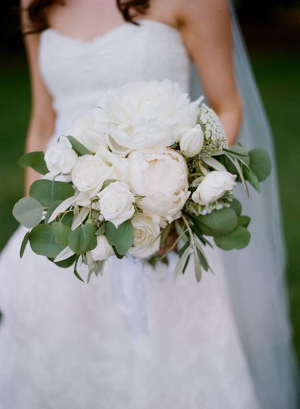a lush white wedding bouquet with peonies, roses and some foliage is an elegant idea