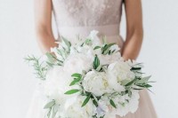 a beautiful and breeze white peony wedding bouquet with various types of greenery is always a gorgeous idea