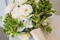 white blooms and catchy greenery wedding bouquet with a shiny wrap on buttons for a rustic look