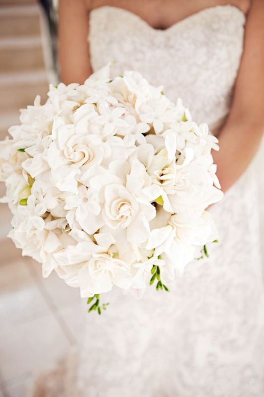 a heavenly white bloom wedding bouquet of various types of flowers shaped as a ball for a romantic touch