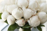 a white wedding bouquet of peony flower buds is a cool idea that guarantees that your flowers won’t wither