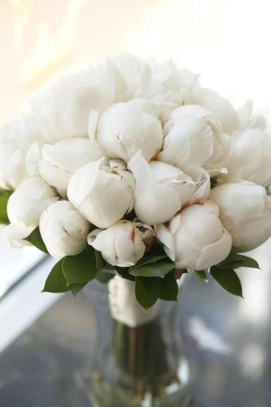 a white wedding bouquet of peony flower buds is a cool idea that guarantees that your flowers won't wither