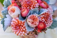 a bright wedding bouquet of peachy pink dahlias, red ranunculus, blush peony roses and pale greenery is a unique solution for a bright wedding