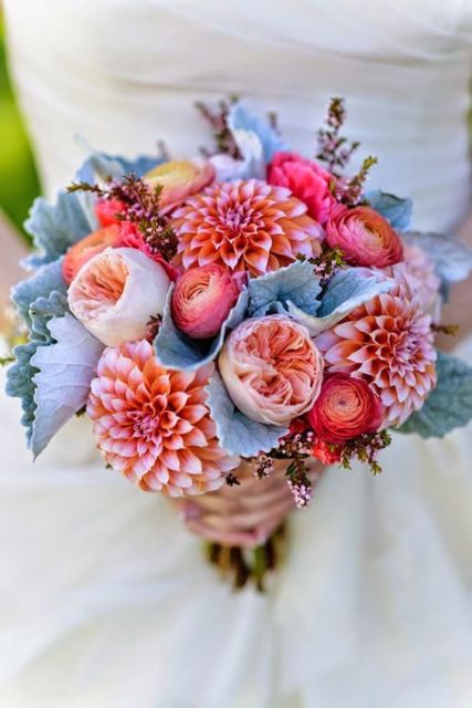 a bright wedding bouquet of peachy pink dahlias, red ranunculus, blush peony roses and pale greenery is a unique solution for a bright wedding