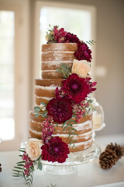 a naked wedding cake decorated with burgundy dahlias, blush roses and some greenery is a gorgeous idea for a summer or fall wedding