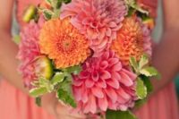 a colorful wedding bouquet composed of pink and orange dahlias is a lovely idea for a bright summer wedding