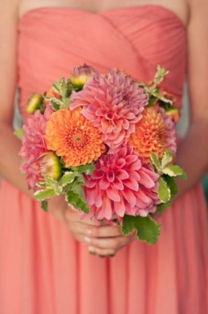 a colorful wedding bouquet composed of pink and orange dahlias is a lovely idea for a bright summer wedding
