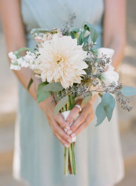 a neutral wedding bouquet of a creamy dahlia, some neutral blooms and greenery is a lovely idea for a spring or summer wedding