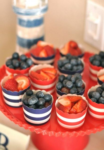 serve fresh berries in striped cups to highlight your nautical theme