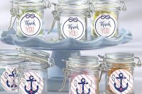 candies packed into stylish jars with anchor stickers are a simple budget-friendly idea for a nautical bridal shower