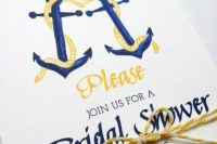 a bright navy and yellow invitation with anchors is a cool idea for a nautical bridal shower