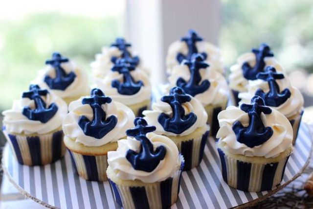 cupcakes with icing and blue edible anchors are nice for a nautical bridal shower or wedding