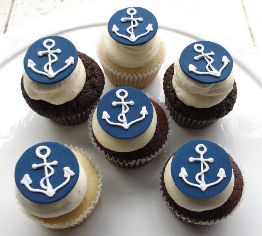 vanilla and chocolate cupcakes with anchor toppers are a great themed treat for a nautical bridal shower