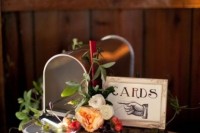 a rough wooden box with a frame and a mailbox where the guests will leave their cards for the couple