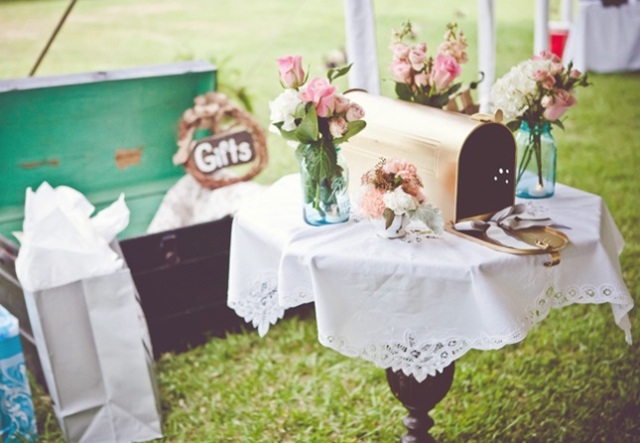 a simple mailbox with blooms around in the jars is a cool idea for a rustic wedding