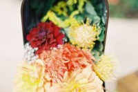 use a mailbox as a wedding decoration with bright blooms and greenery for an effortless and chic look