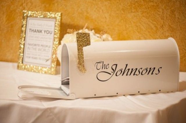 a white mailbox with a gold glitter flag and the name of the couple is a chic and stylish idea