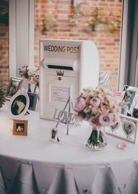 a vintage white wedding mailbox surrounded with your couple's photos and pastel blooms in jars