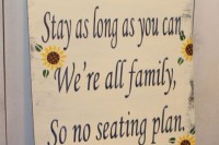a cozy rustic sign with sunflowers is a cool idea for any rustic wedding, very inspiring