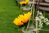 decorate your wedding aisle with baby’s breath, sunflowers in a jar for a slight rustic touch