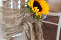 burlap chair decor with sunflowers is a cool rustic idea to go for