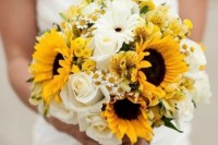 a bright wedding bouquet composed of white and sunny yellow blooms plus some greenery for a rustic bride
