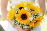 a rustic wedding bouquet of sunflowers, baby’s breath and some greenery for a cute look