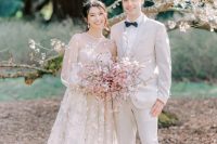 a beautiful blush A-line wedding dress with puff sleeves and pink cherry blossom applique is a lovely idea for a spring bride