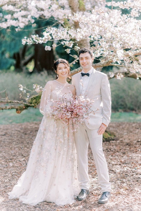 a beautiful blush A-line wedding dress with puff sleeves and pink cherry blossom applique is a lovely idea for a spring bride