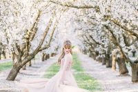 a beautiful blush wedding dress echoes with the blooming cherry trees around, a perfect location for your wedding portraits