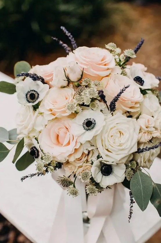 a beautiful summer wedding bouquet of white and blush roses, white anemones, lavender, eucalyptus is amazing