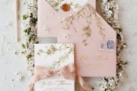 a beautiful wedding invitation suite with pink envelopes and cherry blossom prints plus blush ribbon is amazing for spring