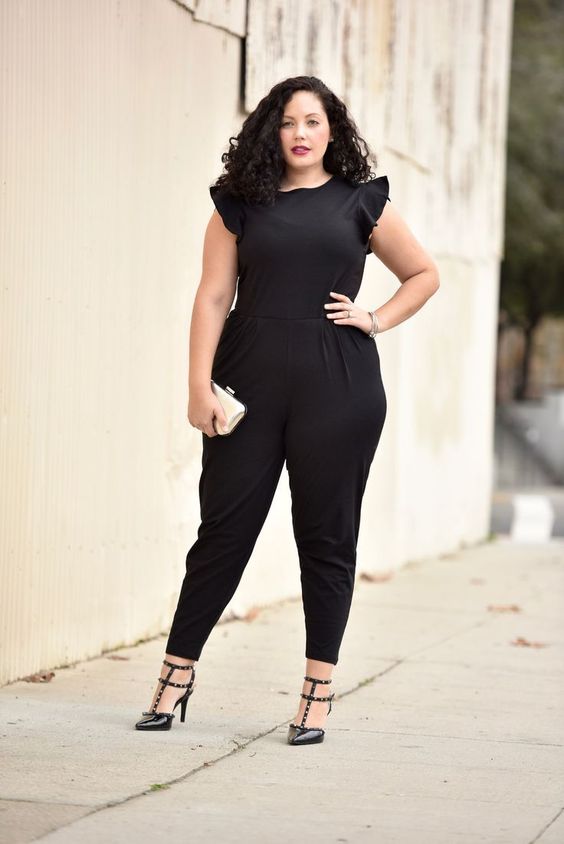 a black jumpsuit with ruffled cap sleeves, spiked shoes and a little shite clutch for a modern look