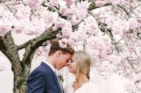 a blooming cherry orchard will be a gorgeous idea to take wedding portraits, it will create an utterly romantic ambience