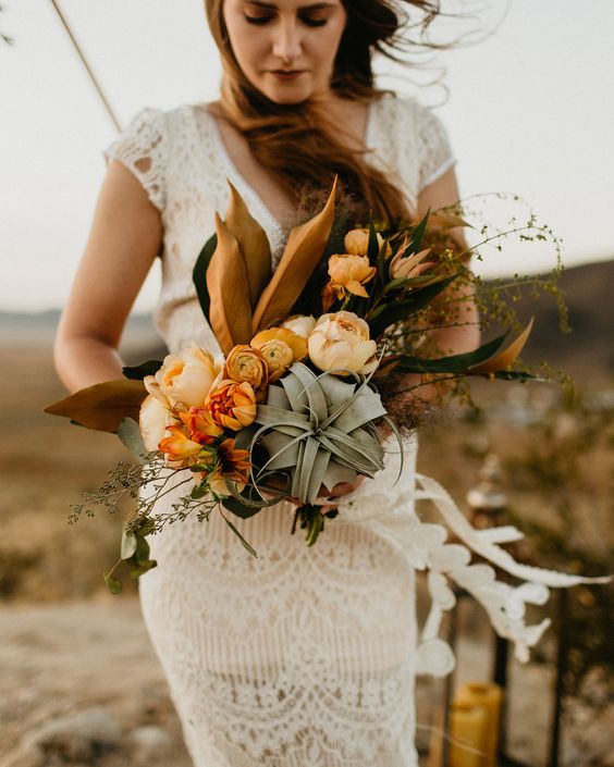 a boho wedding bouquet of blush and rust blooms, an air plant, bold foliage and greenery is a unique solution