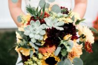 a bold fall wedding bouquet with pale succulents, eucalyptus, peachy and yellow blooms and sunflowers