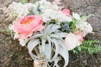 a bold wedding bouquet of white and pink blooms, greenery, air plants, thistles and ribbon is a stylish solution