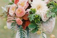 a bold wedding bouquet of white and pink dahlias, blush blooms, seed pods, greenery and blue ribbon is a lovely idea for summer or fall