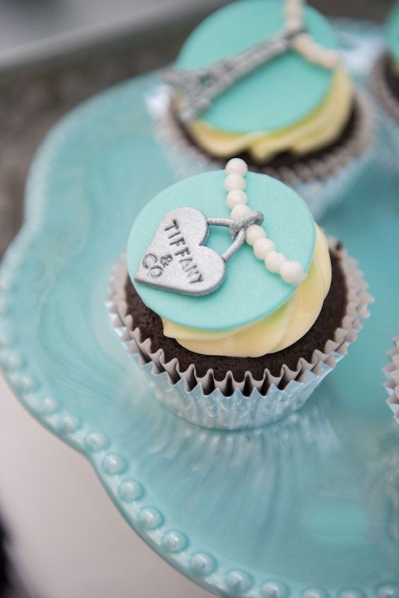 a breakfast at Tiffany themed cupcake with ivory, tiffany blue and silver icing