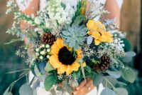 a chic and textural wedding bouquet of white blooms, greenery, sunflowers, succulents and pinecones