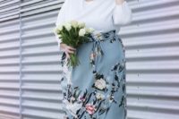 a chic knee gown with a white bodice with long sleeves and a light blue floral skirt, light blue shoes