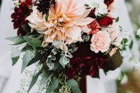 a contrasting fall wedding bouquet with deep purple and burgundy roses and dahlias, blush roses and dahlias, lisianthus and greenery
