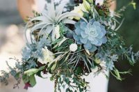 a cool wedding bouquet of greenery, white blooms, succulents and an air plant is an amazing idea for a non-flora wedding