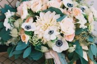 a delicate summer wedding bouquet in pastels with blush roses, dahlias and white anemones plus lots of eucalyptus