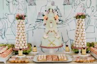 a fantastic Parisian style sweets table with a macaron tower, a light green cake, various delicious desserts and greenery